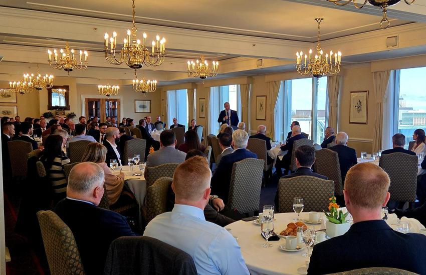 Attendees seated at tables in a large banquet room