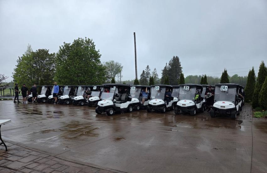 golf carts lined up for a charity golf tournament