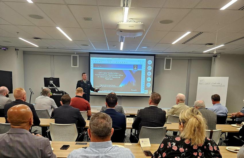 attendees seated for training with presenter at the front of the room